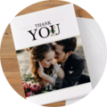A thank you card with two people and flowers in the foreground, standing lovingly together