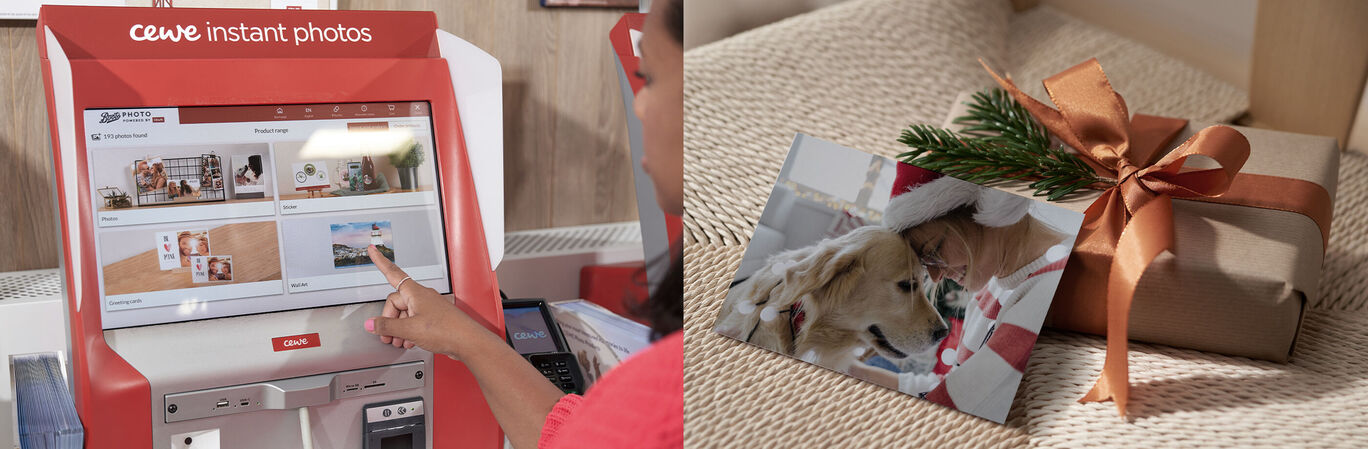 A person points at a CEWE instant photo machine with images on the screen and a gift with a photo and a green plant.